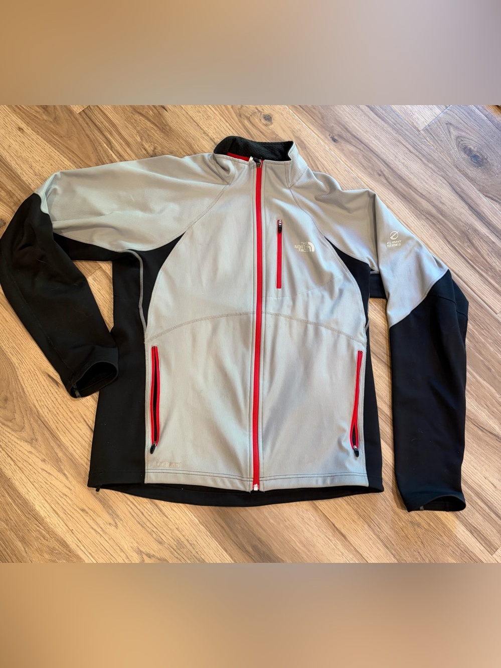 The North Face Flight Series Light Gray & Black Jacket with Red Zippers.   L.